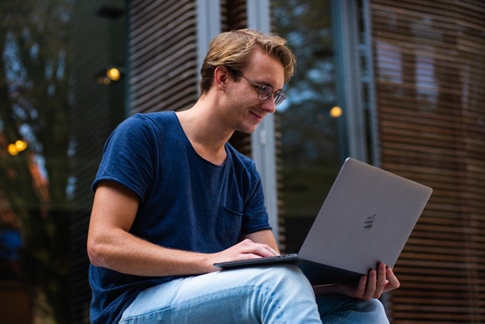 man on laptop doing automation marketing