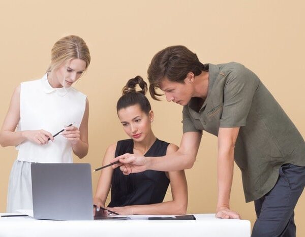 two woman and one man looking at the laptop 1036641 3