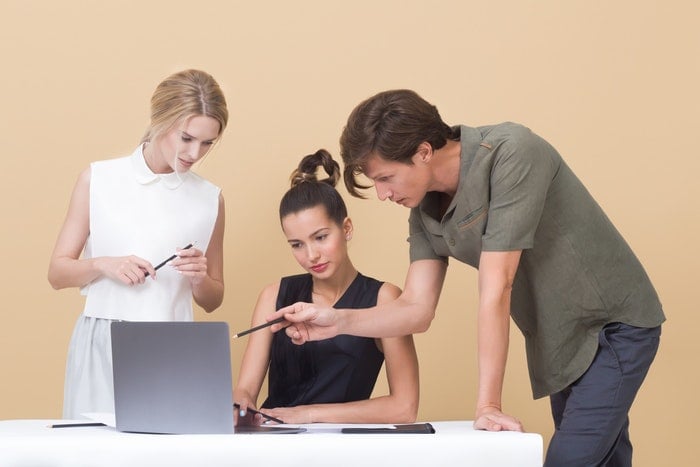 two woman and one man looking at the laptop 1036641 3