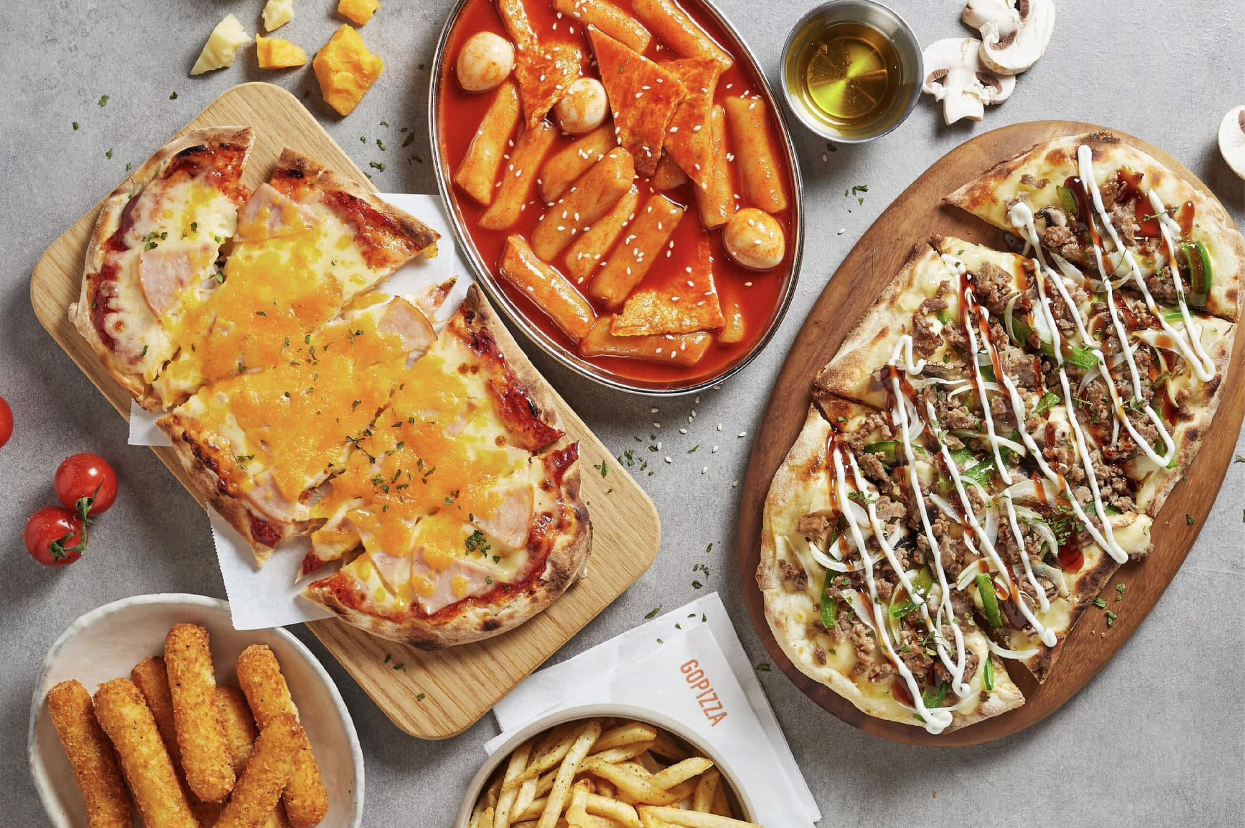 GOPIZZA menu spread: flatbread pizzas, tteokbokki, cheese sticks and fries